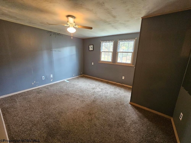 empty room with ceiling fan, a textured ceiling, and carpet