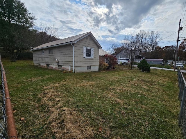 view of side of property with a yard