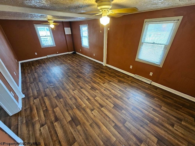 empty room with dark wood-type flooring, a textured ceiling, and ceiling fan