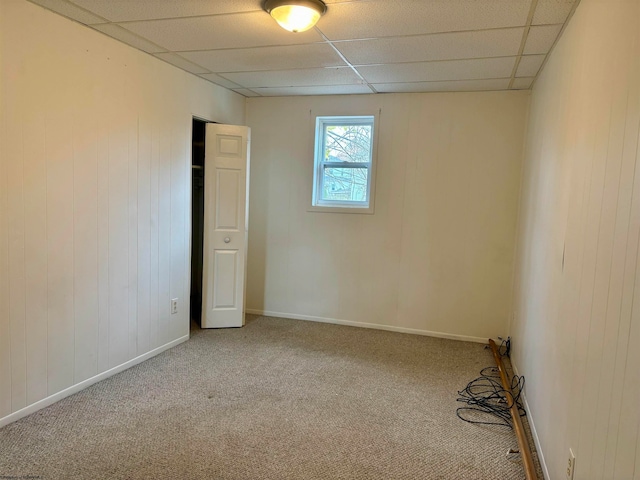 unfurnished room featuring a drop ceiling and carpet flooring