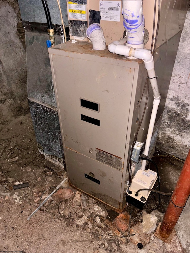 utility room featuring heating unit