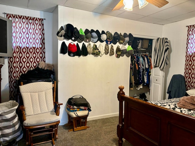 carpeted bedroom with ceiling fan and a closet