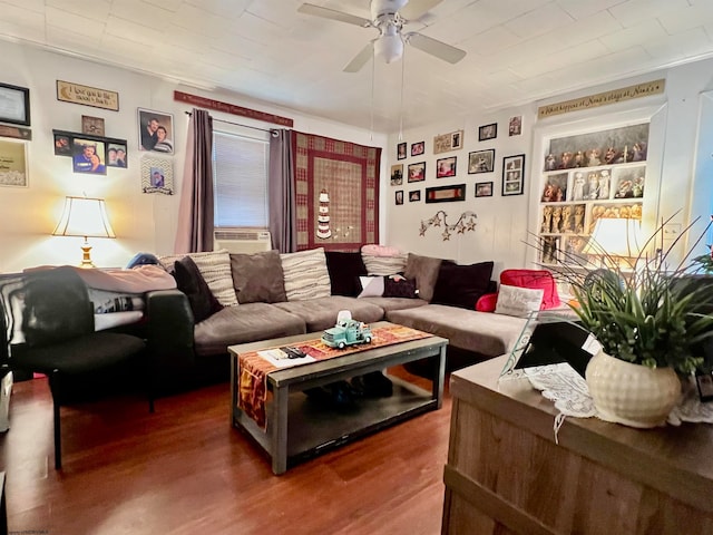 living room featuring cooling unit, hardwood / wood-style flooring, ceiling fan, and crown molding