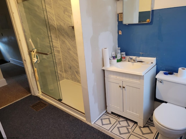 bathroom with walk in shower, vanity, and toilet