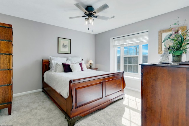 bedroom with ceiling fan and light carpet