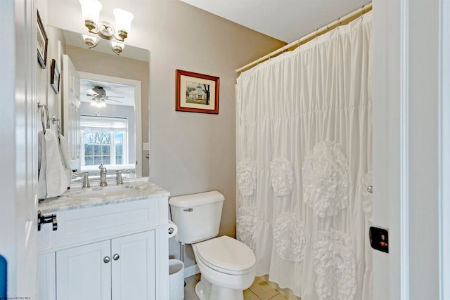 bathroom with toilet, vanity, tile patterned flooring, and ceiling fan