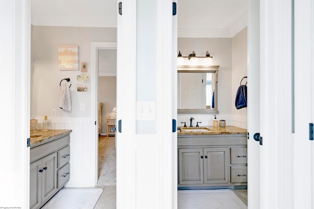 bathroom featuring ornamental molding, tile patterned flooring, and vanity