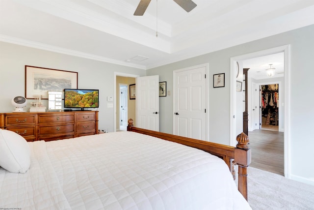 bedroom with light hardwood / wood-style floors, ceiling fan, and ornamental molding