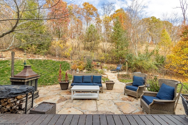 deck with outdoor lounge area and a patio