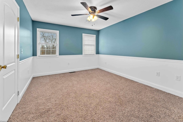 unfurnished room featuring ceiling fan and carpet floors