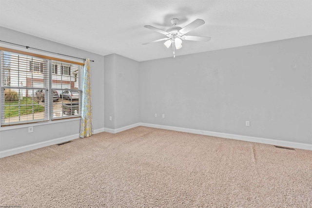 spare room with carpet flooring and ceiling fan