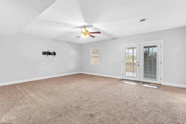 unfurnished room featuring ceiling fan, a textured ceiling, carpet flooring, and french doors