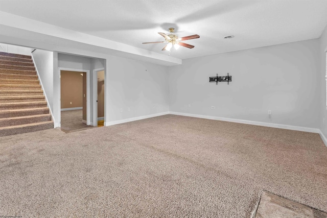 spare room featuring ceiling fan and carpet floors