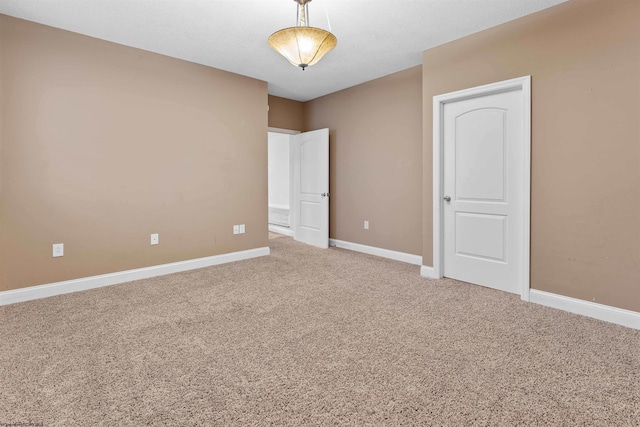 unfurnished room featuring carpet flooring