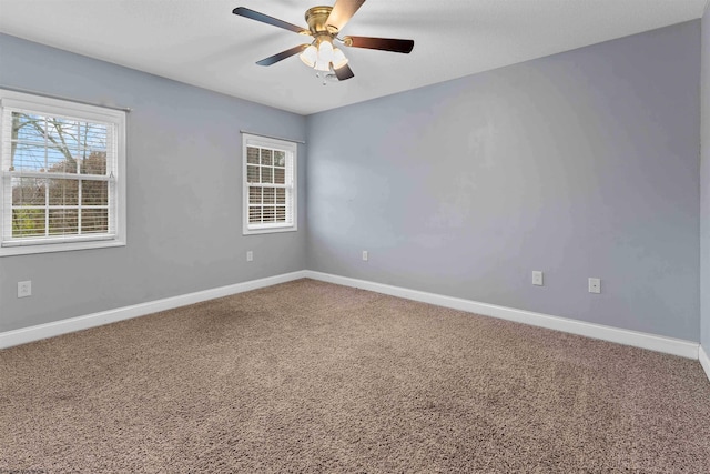 carpeted empty room featuring ceiling fan