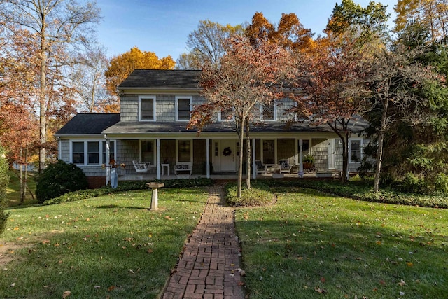 view of front of home featuring a front yard and covered porch