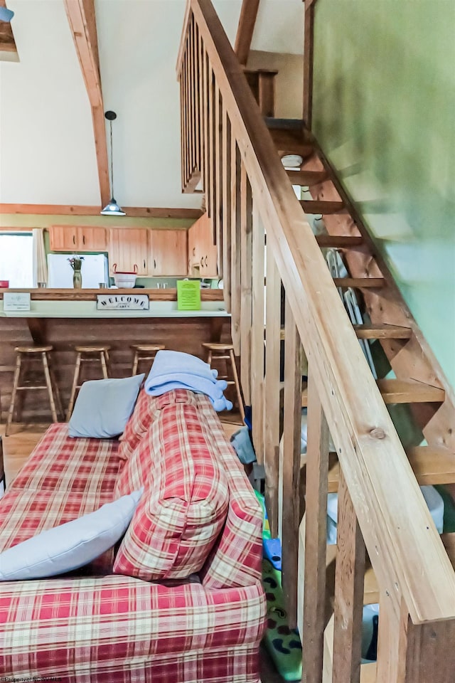 stairway featuring beam ceiling