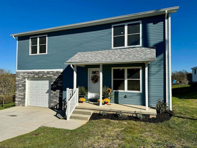 view of property with a garage and a front yard