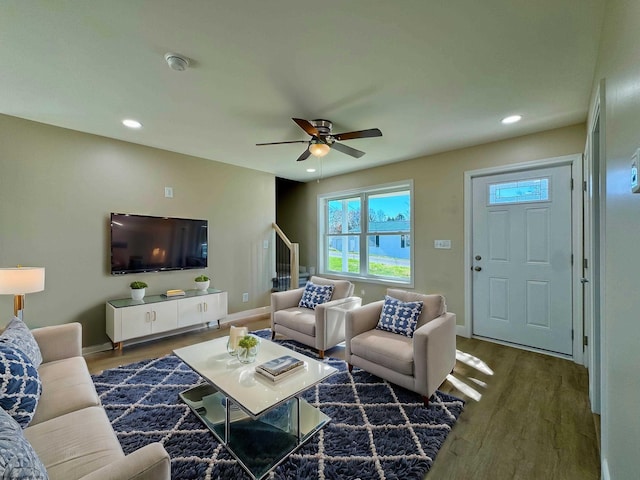 living room with dark wood-type flooring and ceiling fan