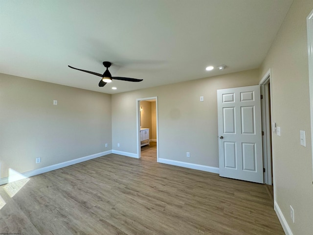 unfurnished bedroom with ensuite bathroom, light hardwood / wood-style floors, and ceiling fan