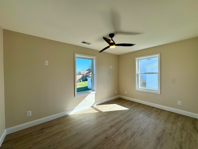 unfurnished room with hardwood / wood-style floors and ceiling fan