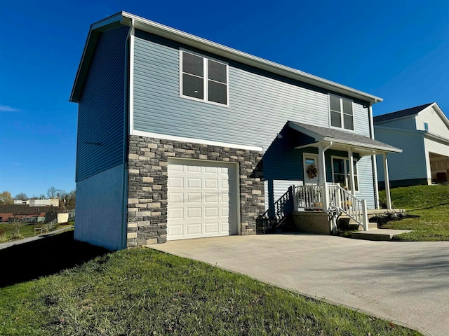 view of front facade with a front lawn, a garage, and covered porch