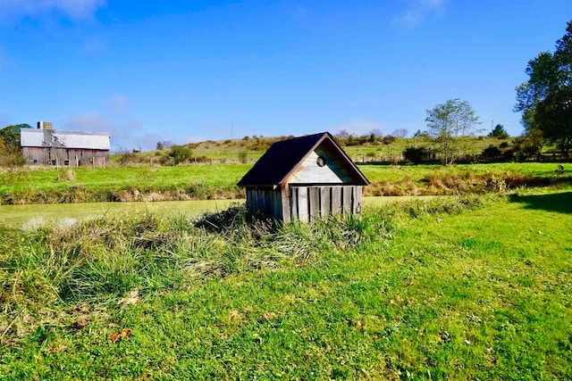 view of outdoor structure with a rural view