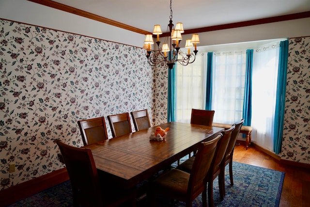 dining space with hardwood / wood-style floors, a chandelier, and ornamental molding