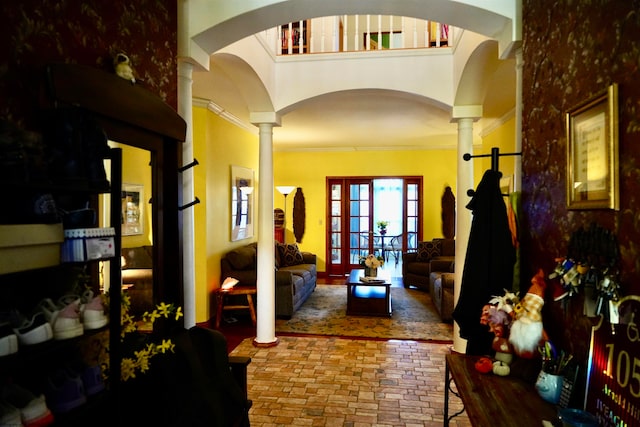 interior space featuring ornate columns and ornamental molding