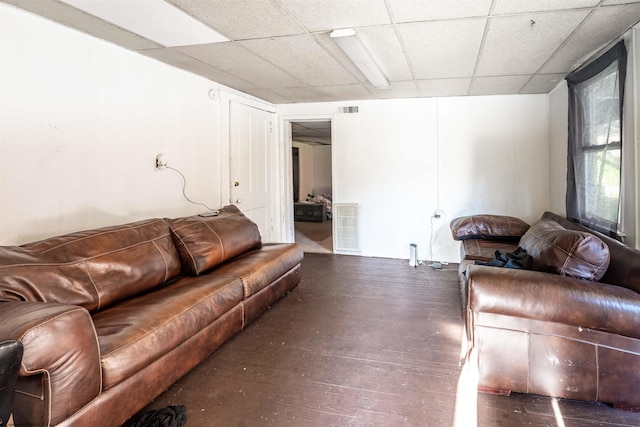 living room with a paneled ceiling and dark wood-type flooring