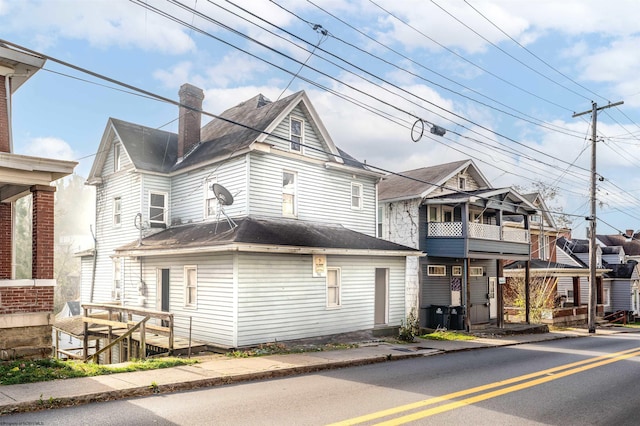 view of side of home with a balcony