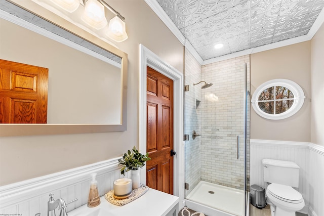 bathroom featuring toilet, an enclosed shower, and crown molding