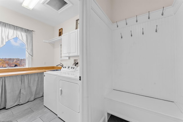 laundry room with cabinets and washing machine and clothes dryer