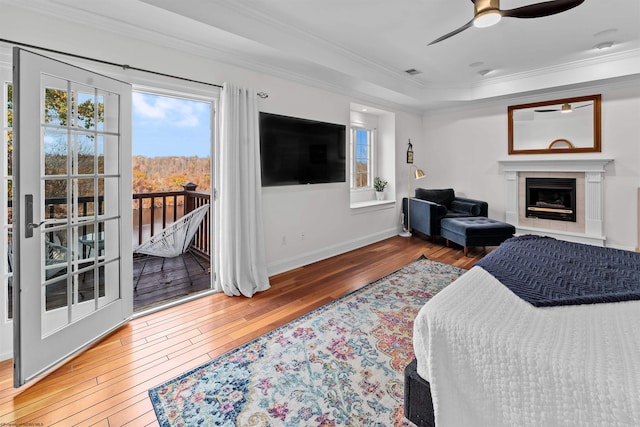 bedroom featuring ornamental molding, access to outside, wood-type flooring, and ceiling fan