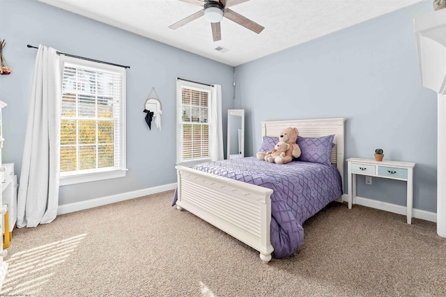 bedroom featuring carpet, a textured ceiling, and ceiling fan