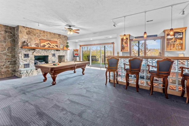 game room featuring billiards, rail lighting, a textured ceiling, and ceiling fan