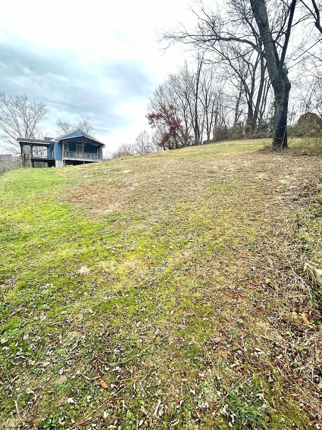 view of yard with a rural view and a sunroom