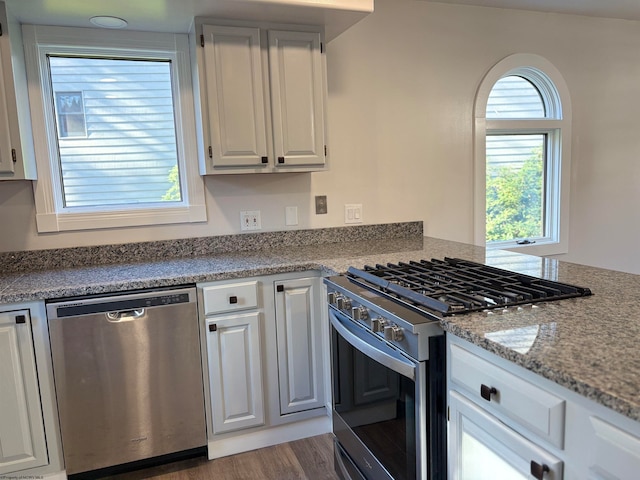 kitchen featuring white cabinetry, stainless steel appliances, and dark hardwood / wood-style flooring