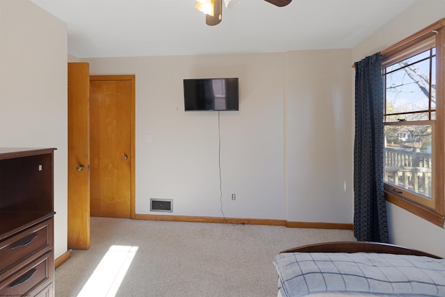 bedroom with light carpet and ceiling fan