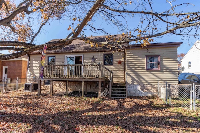 back of property featuring central AC unit and a wooden deck