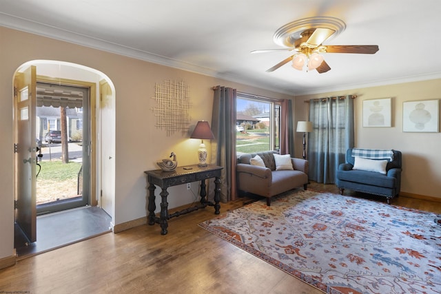 interior space featuring hardwood / wood-style flooring, ceiling fan, and crown molding