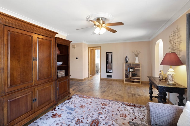 interior space with ornamental molding, hardwood / wood-style flooring, and ceiling fan