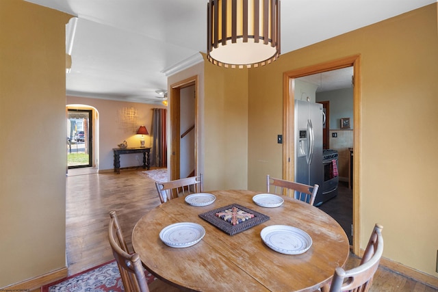 dining space with hardwood / wood-style floors and ceiling fan