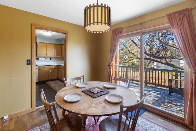 dining space with wood-type flooring