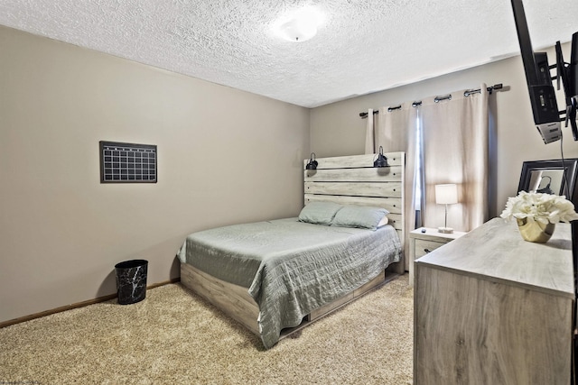 bedroom featuring a textured ceiling and light carpet