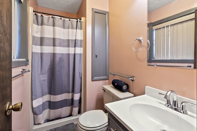 bathroom with vanity, a shower with shower curtain, a textured ceiling, and toilet