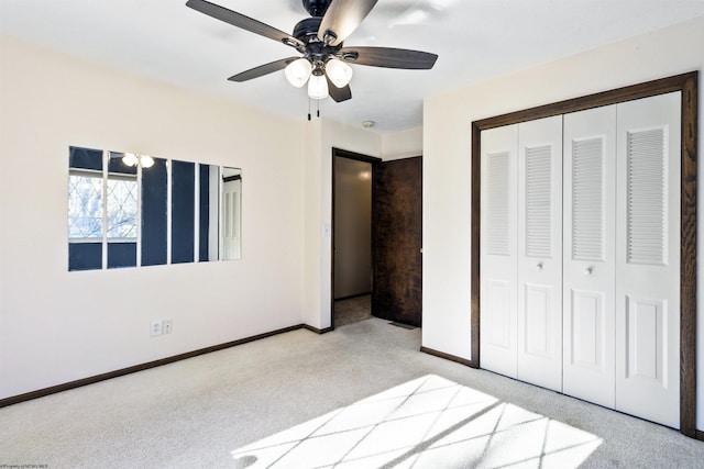 unfurnished bedroom with ceiling fan, a closet, and light colored carpet