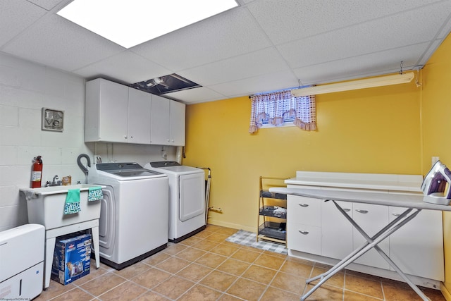 washroom with cabinets and washer and dryer