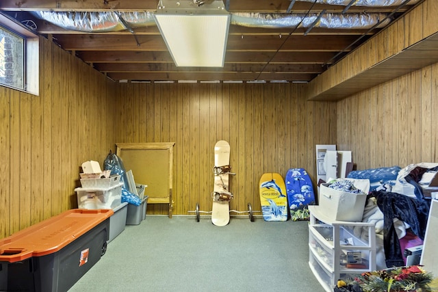 basement with wood walls and carpet floors