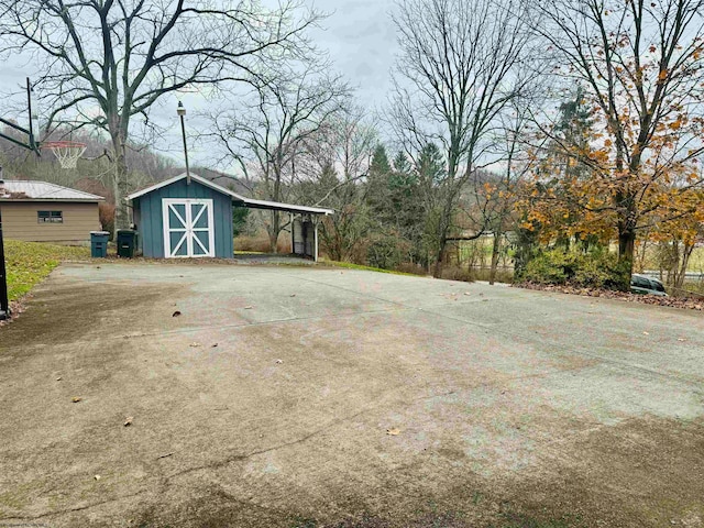 view of patio / terrace with a shed and a carport